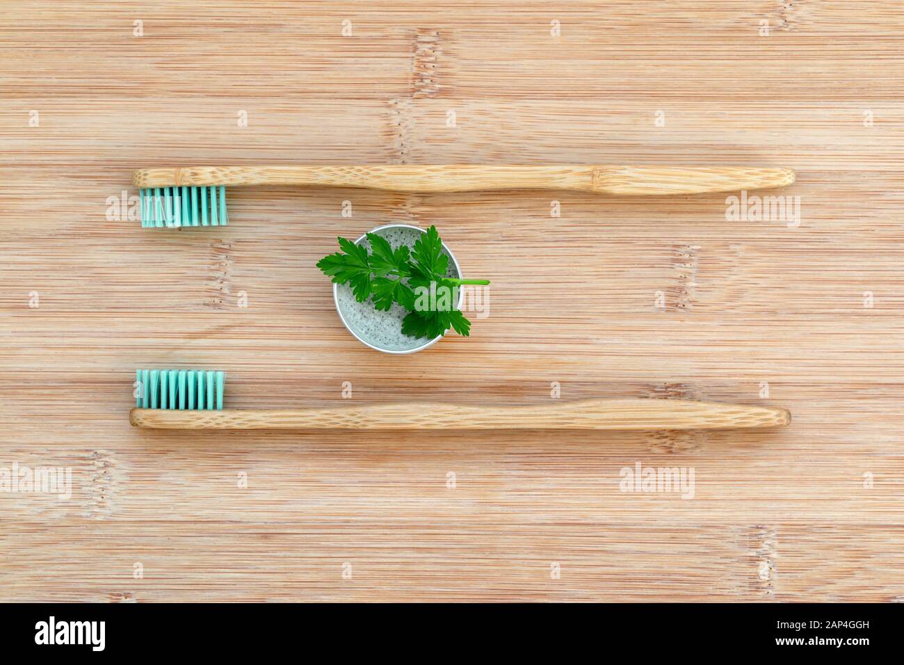 Set of two bamboo toothbrushes and solid toothpaste on wood background. Zero waste, plastic free, environment concept Stock Photo