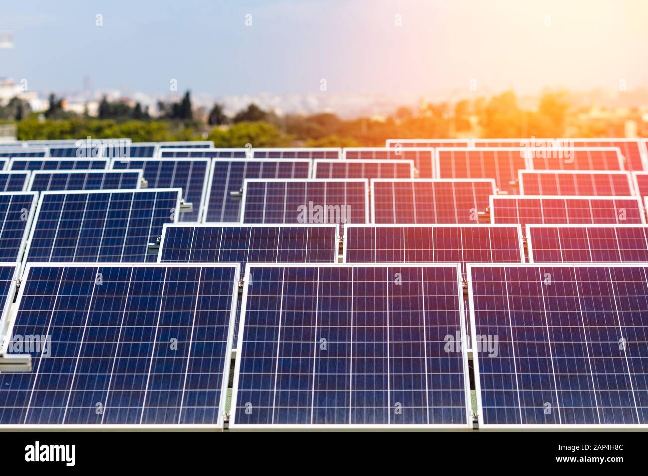 Set of solar panels mounted on roof of building. Renewable energy eco ...