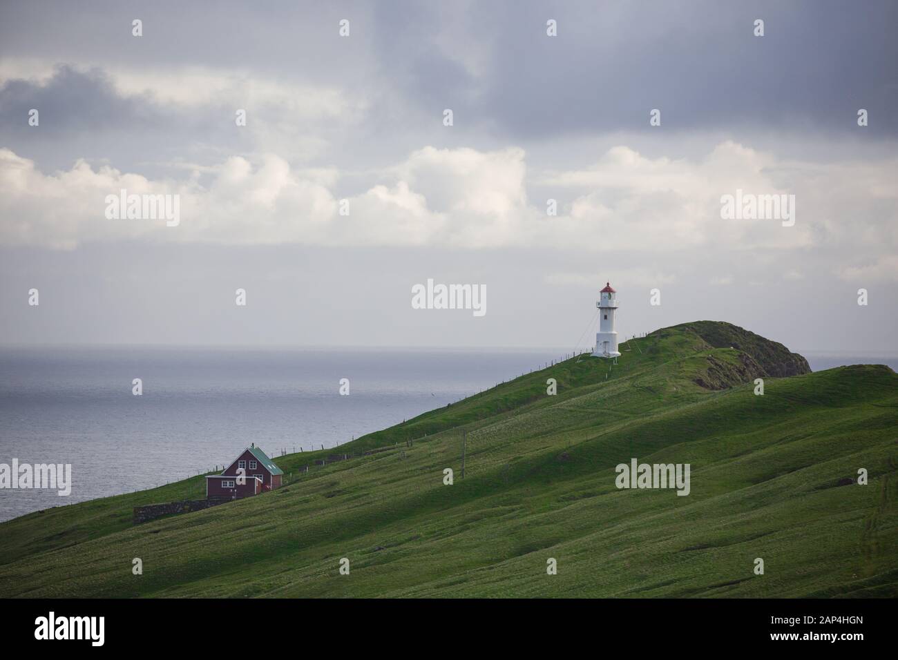Mykines lighthouse, Faroe Islands. Foggy view of old lighthouse/ Stock Photo