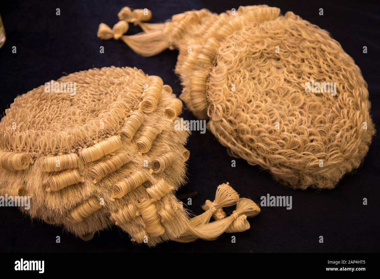 Two wigs as worn by some judges and barristers in England and Wales, also known as a peruke. This picture was taken at a graduation ceremony photoshoo Stock Photo