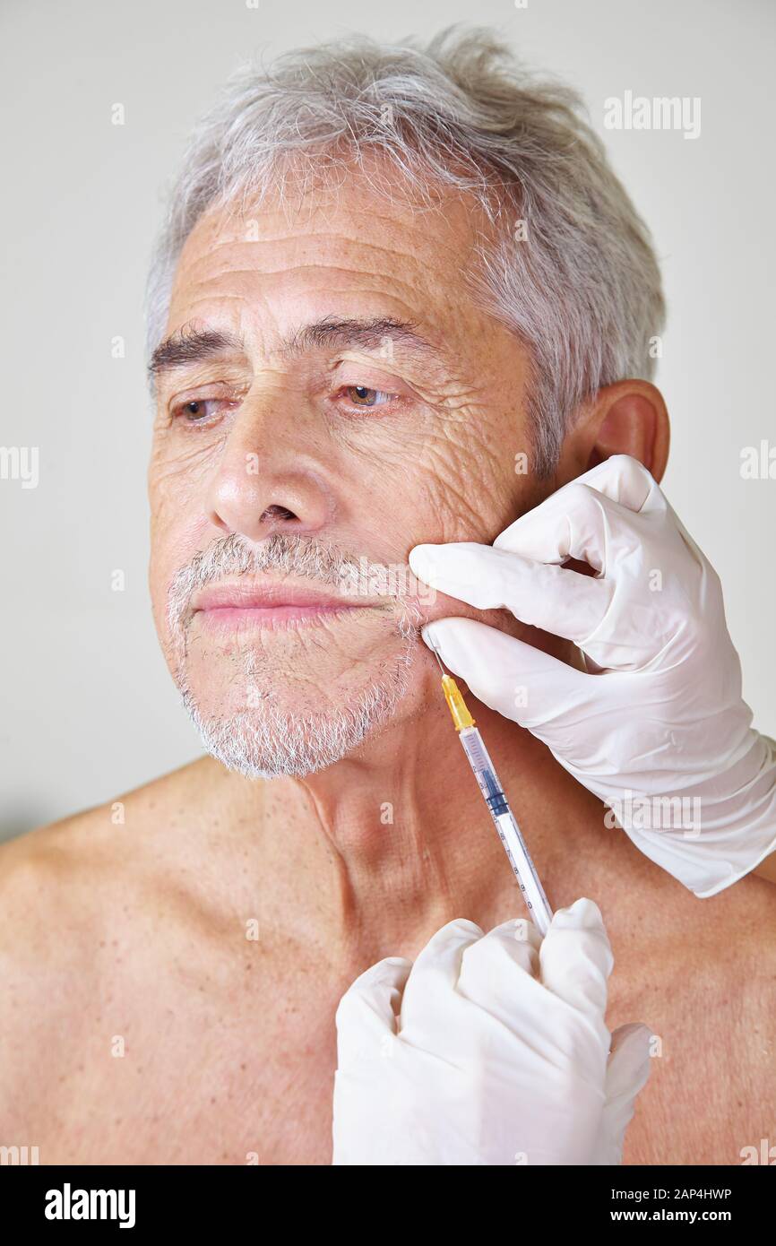 Senior man at the treatment with Botox in a beauty clinic Stock Photo