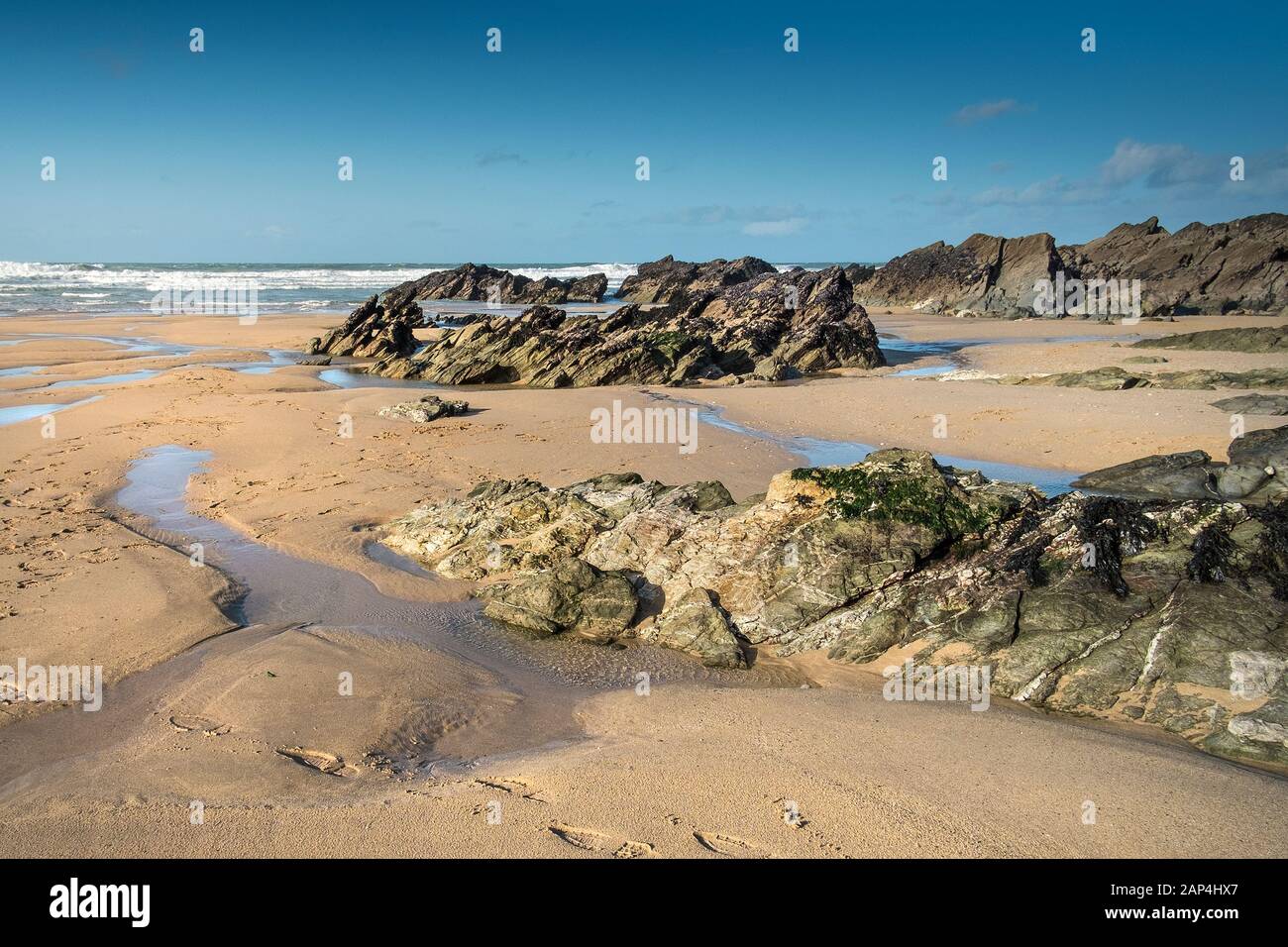 Rocks exposed at low tide on Fistral Beach in Newquay in Cornwall Stock ...