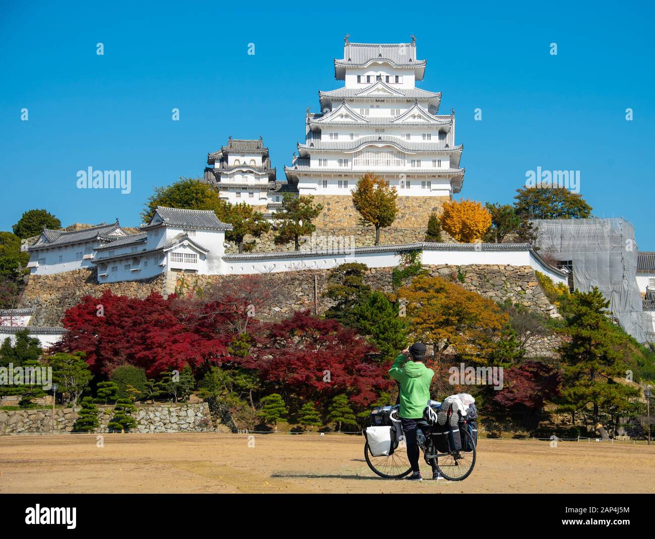 Japanese cycle tourist captures an image of Himeji Castle, Japan. Stock Photo