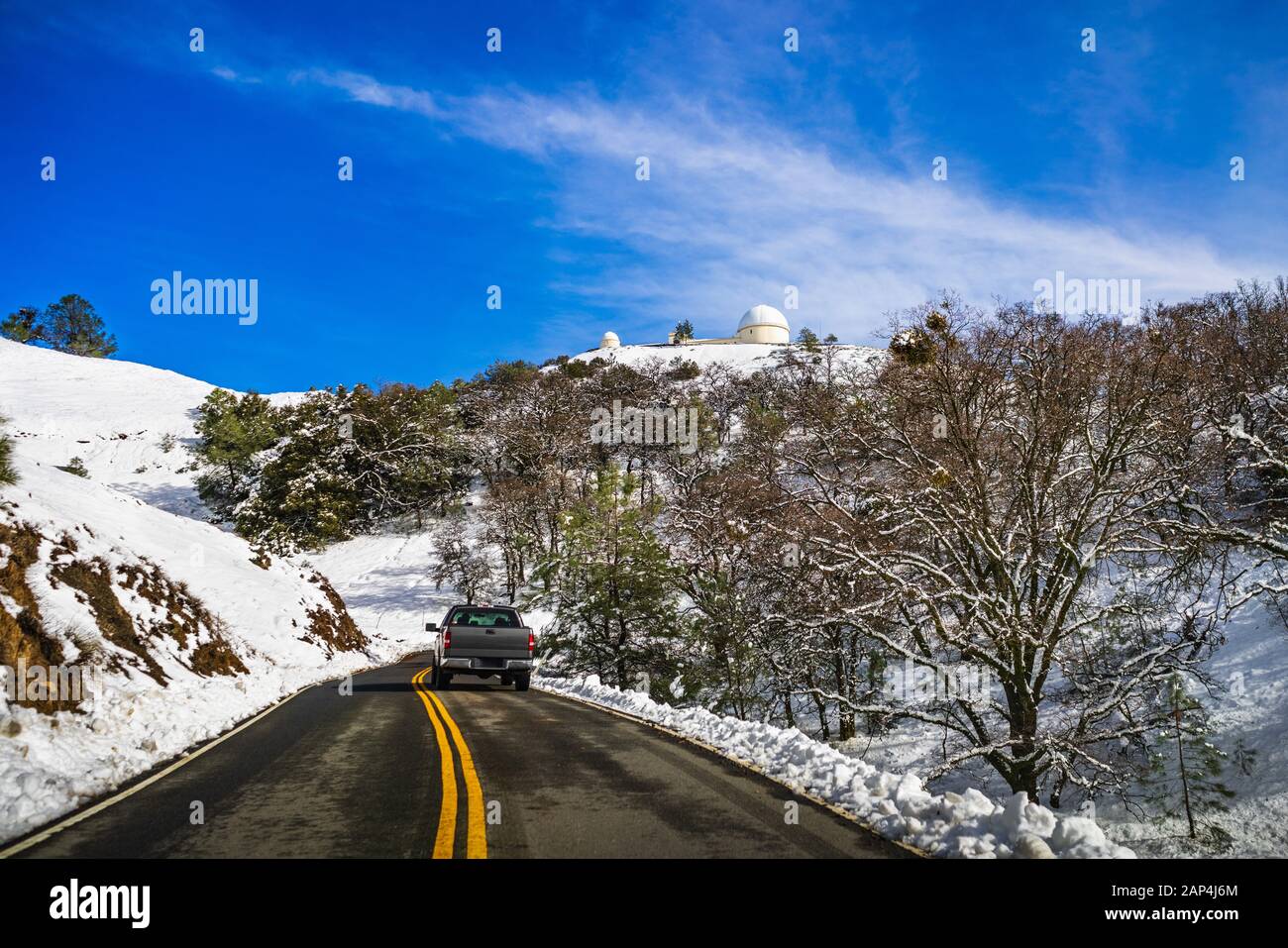 Driving on a snowy winter day towards the top of Mount Hamilton, in the Diablo mountain range; South San Francisco Bay Area, California Stock Photo
