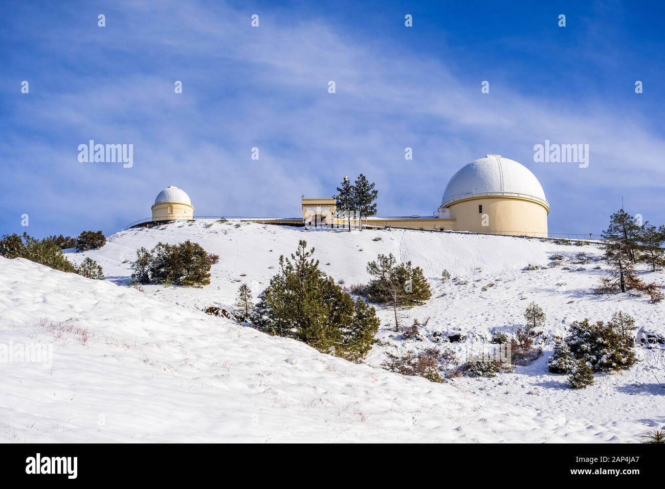 View towards the top of Mt Hamilton on a clear winter day, snow covering the ground; San Jose, San Francisco bay area, California Stock Photo