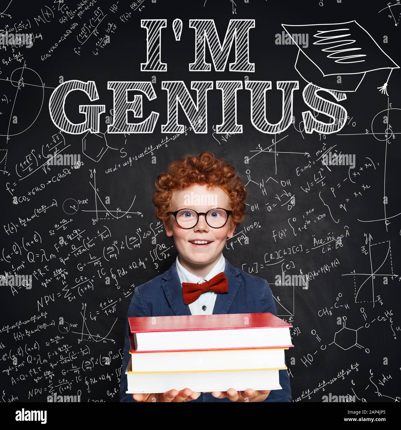 Student child boy genius with books on chalkboard. Kid 9 year old Stock Photo
