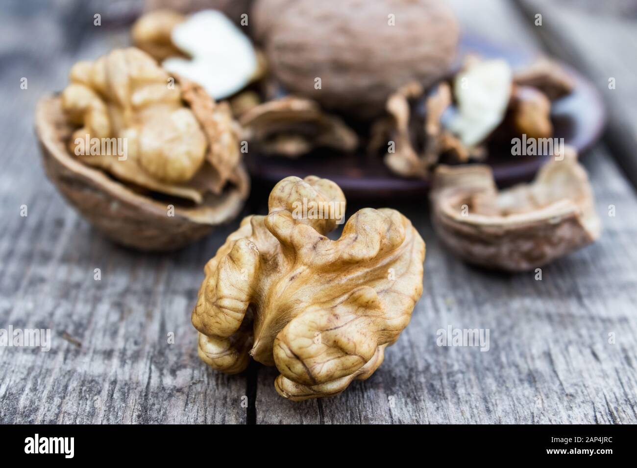 Walnuts kernels on a rustic old wooden table. Fresh walnuts. Harvest walnuts. Stock Photo