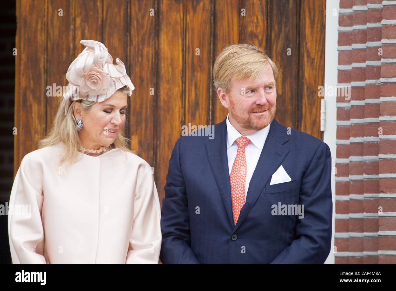 Hoogeveen, the Netherlands - September 18, 2019: royal couple Maxima and Willem-Alexander with hands folded standing in front of the Hoofdstraat churc Stock Photo
