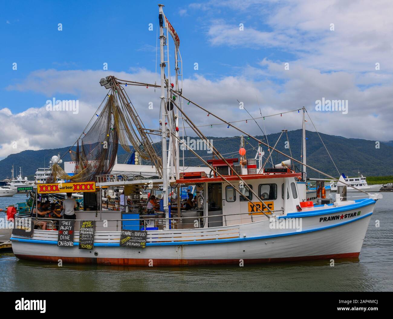 Prawn Star floating seafood restaurant trawler boat with fresh seafood offerings in Cairns Marina, Queensland, Australia Stock Photo