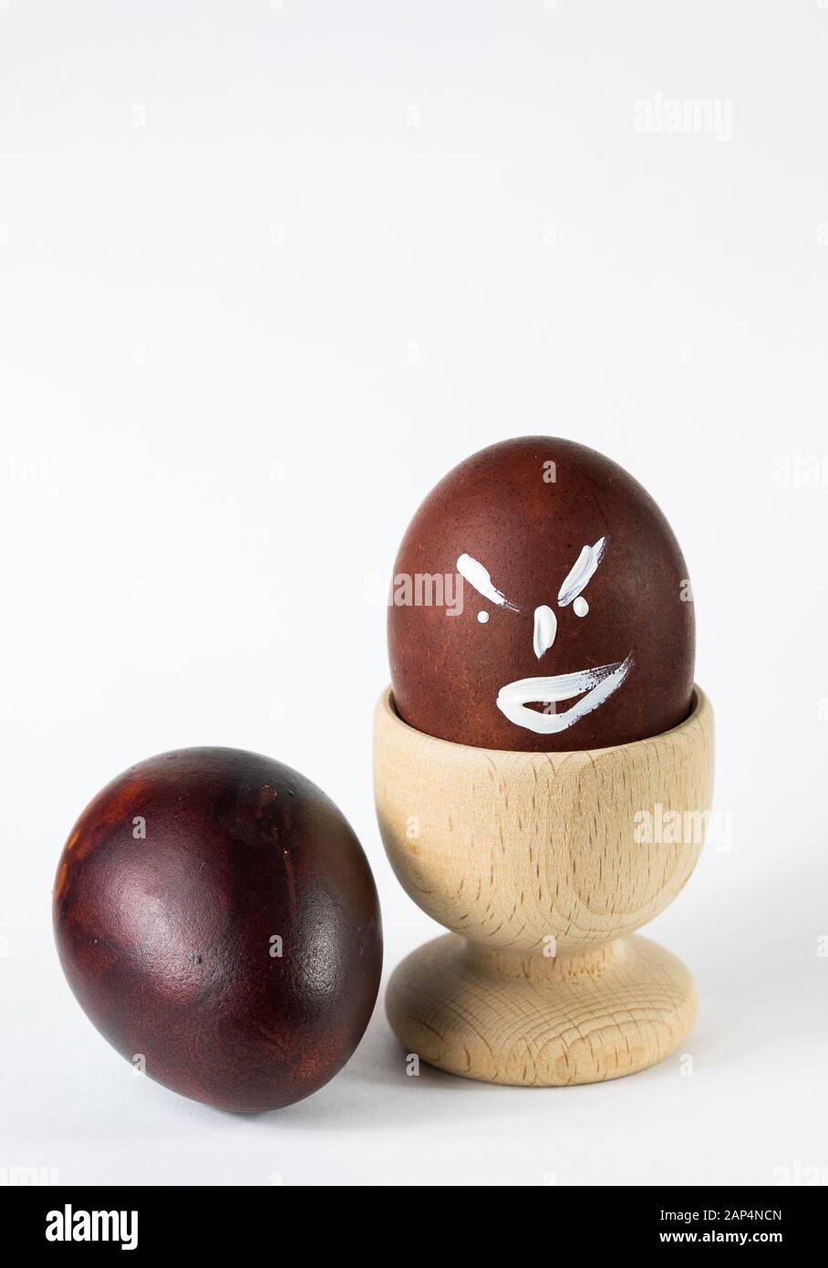 Painted and raw eggs. Funny drawings on eggshells. Easter artistic decoration. Stock Photo