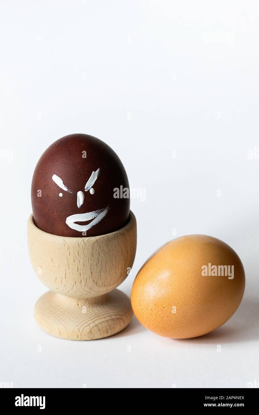 Painted and raw eggs. Funny drawings on eggshells. Easter artistic decoration. Stock Photo