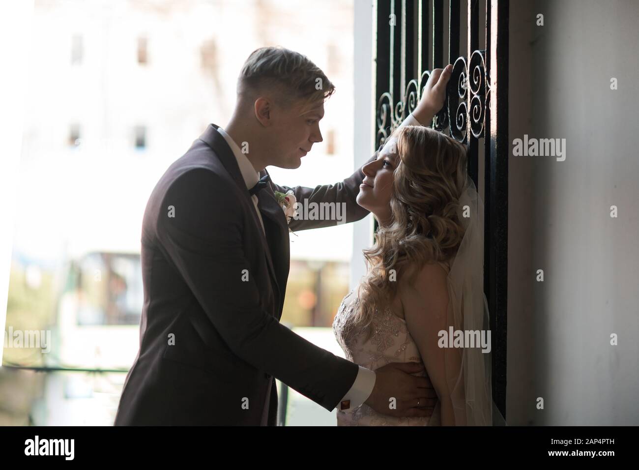 bride and groom talking standing near the door Stock Photo - Alamy