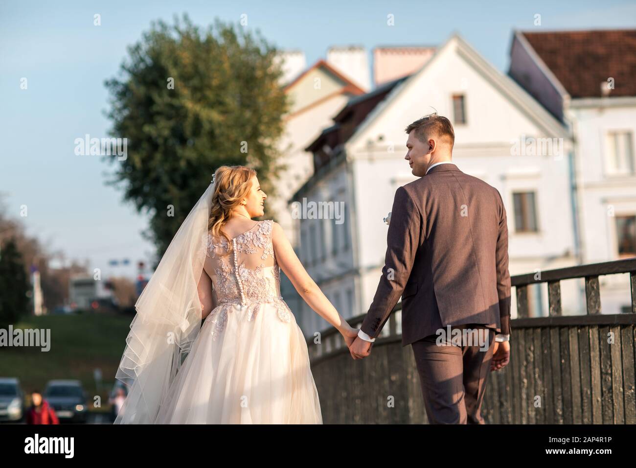 rear view. bride and groom walking down the city street Stock Photo - Alamy