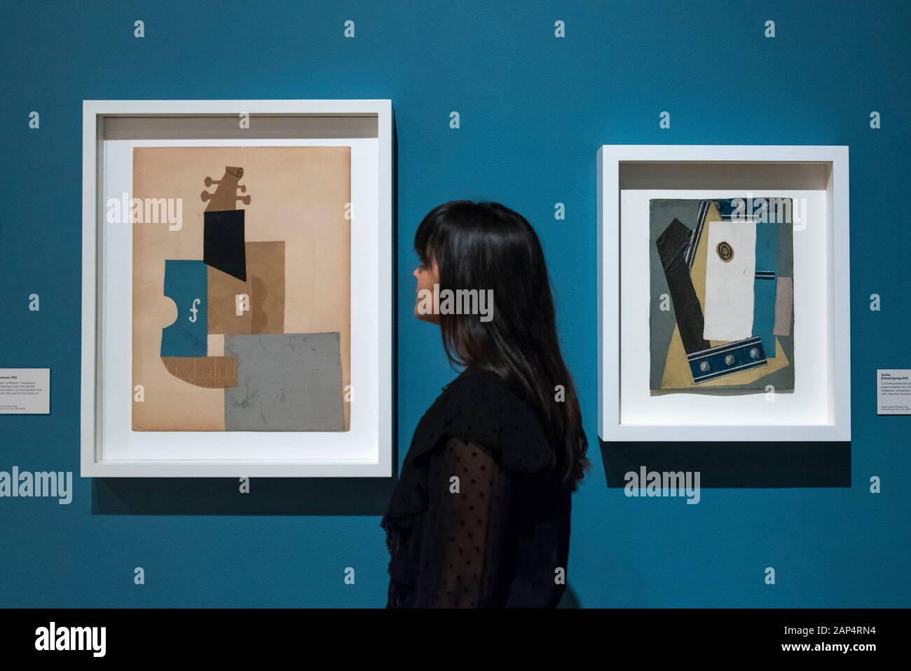 London, UK. 21 January 2020. A staff member views (L to R) "Violin", 1912,  and "Guitar", 1913, both by Pablo Picasso at the preview of "Picasso and  Paper", an exhibition at the