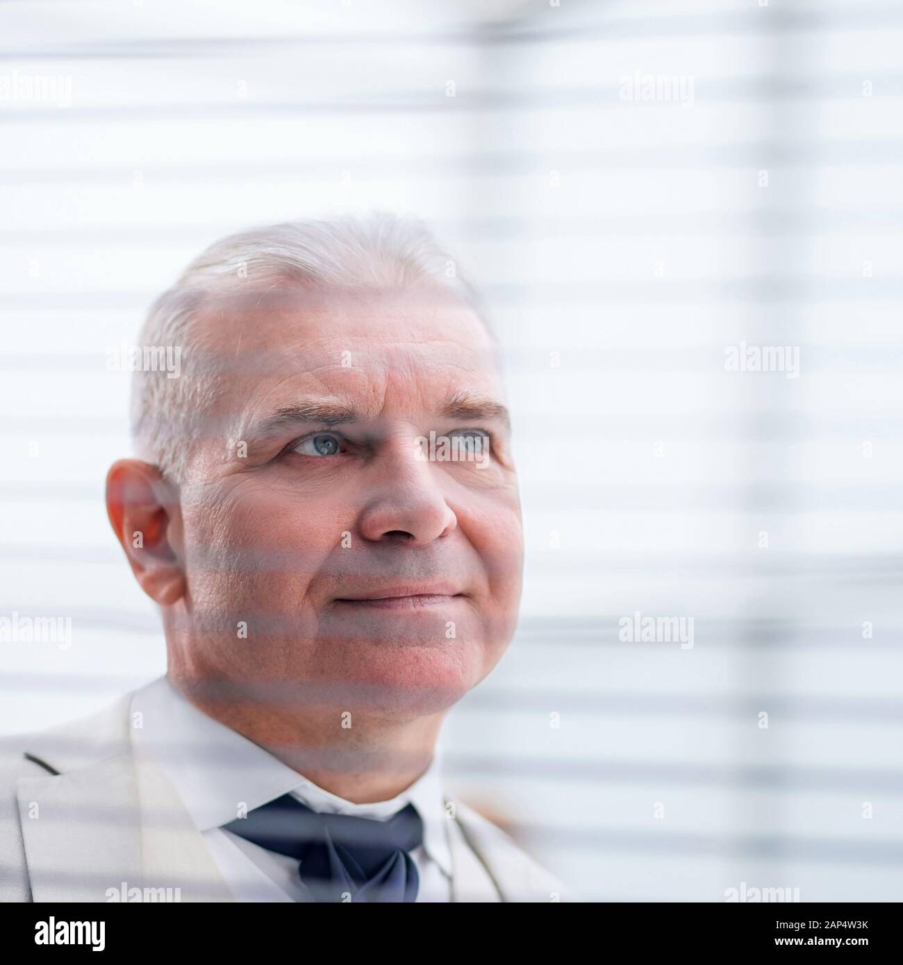 close up. pensive businessman looking through window blinds Stock Photo
