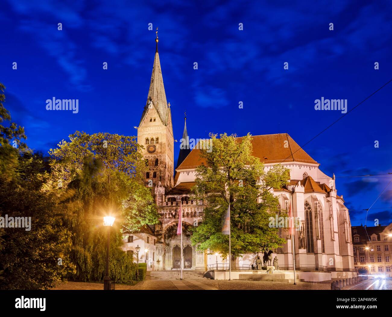 Romanesque Augsburg Cathedral (Augsburger Dom), one of the city's main attractions, illuminated at night. Augsburg, Swabia, Bavaria, Germany Stock Photo