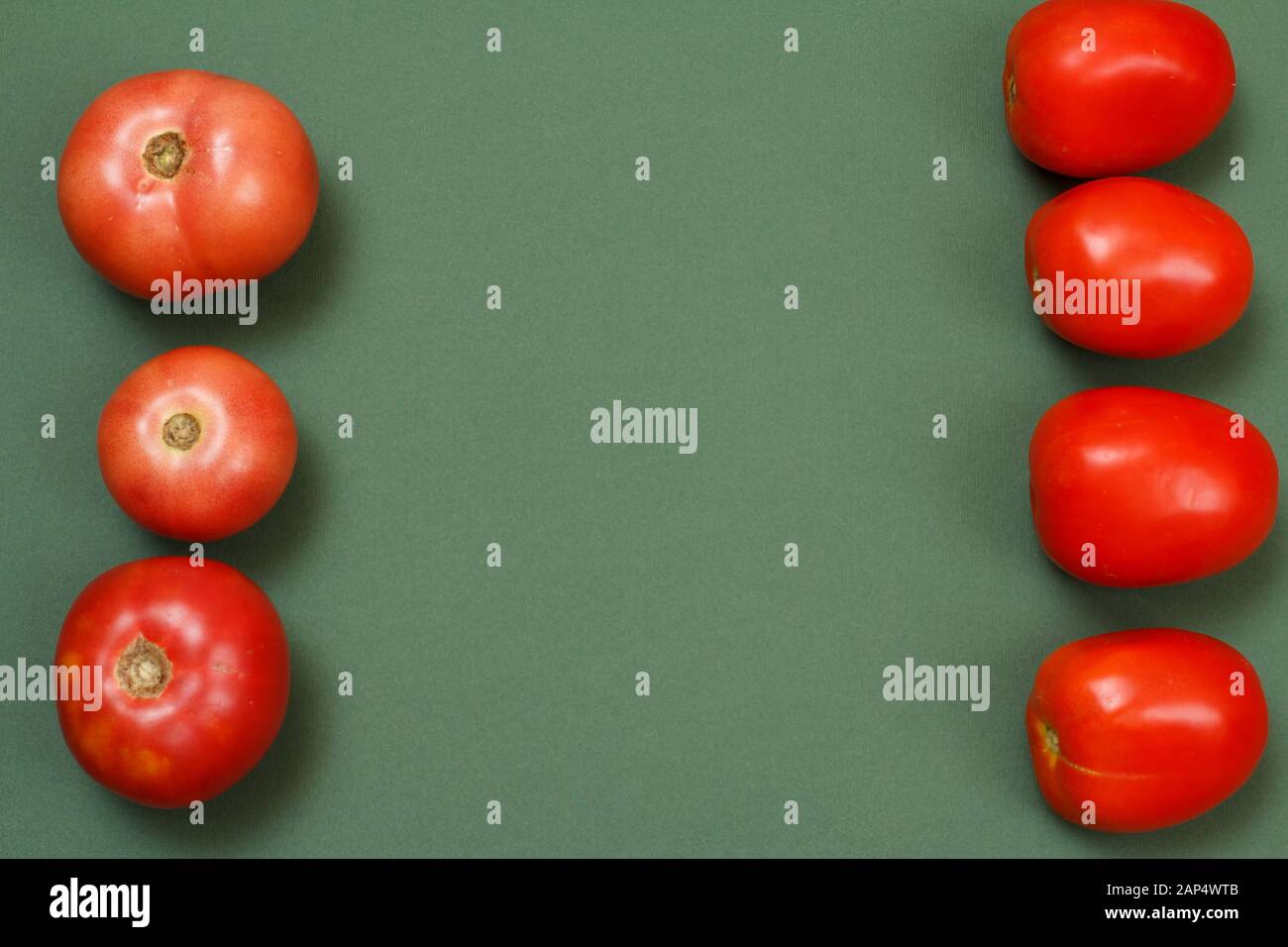 Top view of fresh tomatoes on green background. Vegetables on kitchen table. Top view. Stock Photo