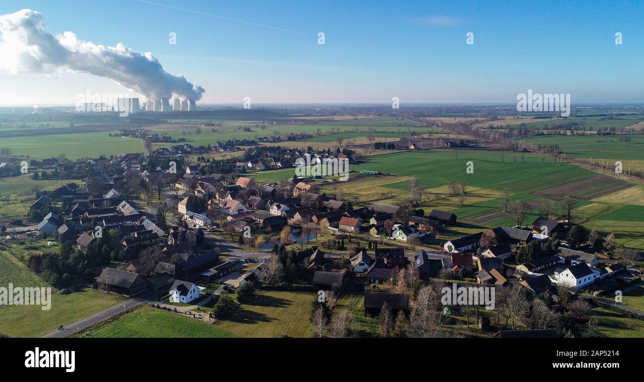21 January 2020, Brandenburg, Jänschwalde-Dorf: Water vapour rises from the cooling towers of the Jänschwalde lignite-fired power plant of Lausitz Energie Bergbau AG (LEAG) behind the village of Jänschwalde-Dorf (aerial photo taken with a drone) The Federal Government's timetable for the phase-out of lignite, with the deadlines for the Jänschwalde and Schwarze Pumpe power plants (both Spree-Neisse), has been received differently in the Brandenburg Lausitz region. According to plans, the Jänschwalde lignite-fired power plant is to be shut down between 2025 and 2028. Two blocks have already been Stock Photo