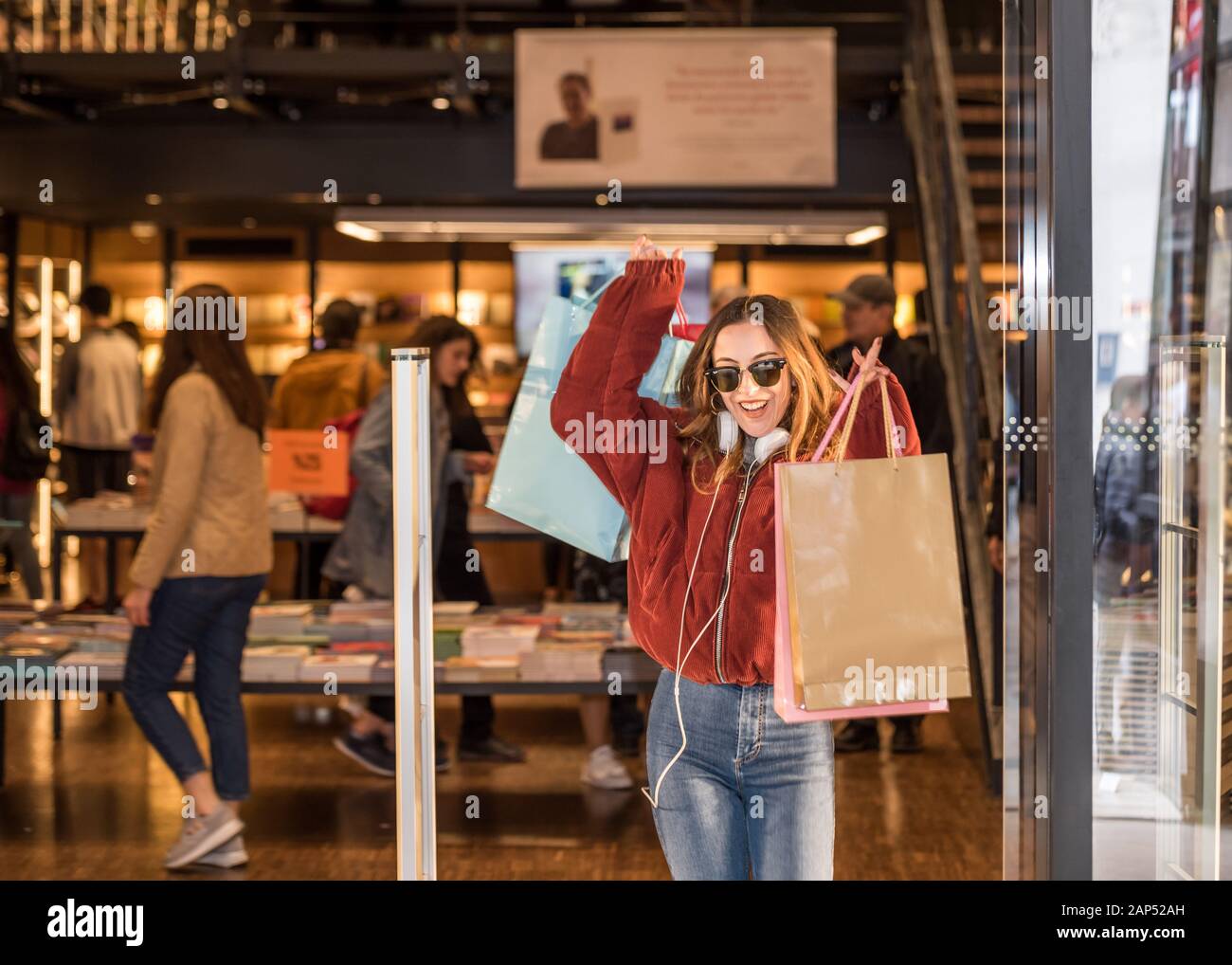 Beautiful attractive young girl in jumper and jeans with sunglasses and