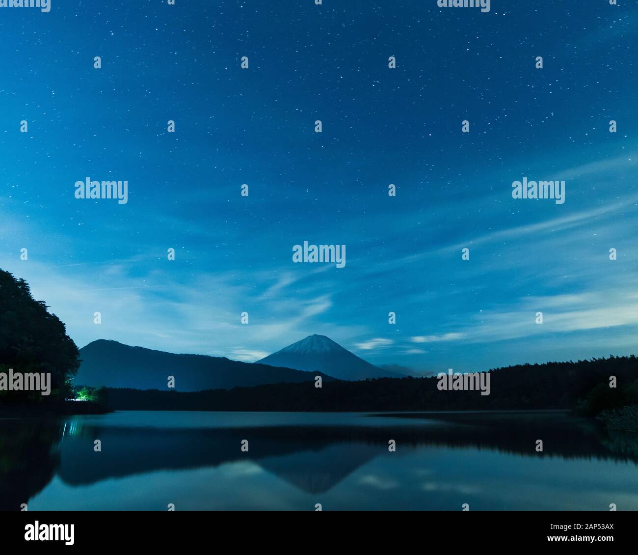 View of the starry sky over Mount Fuji on a peaceful night from lake ...