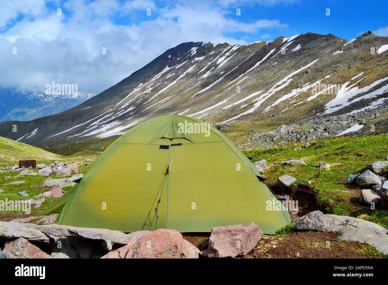 Sleeping in the tent below the Kazbek Mountain above the small city of Stepantsminda. Sunny day, beautiful views. Stock Photo