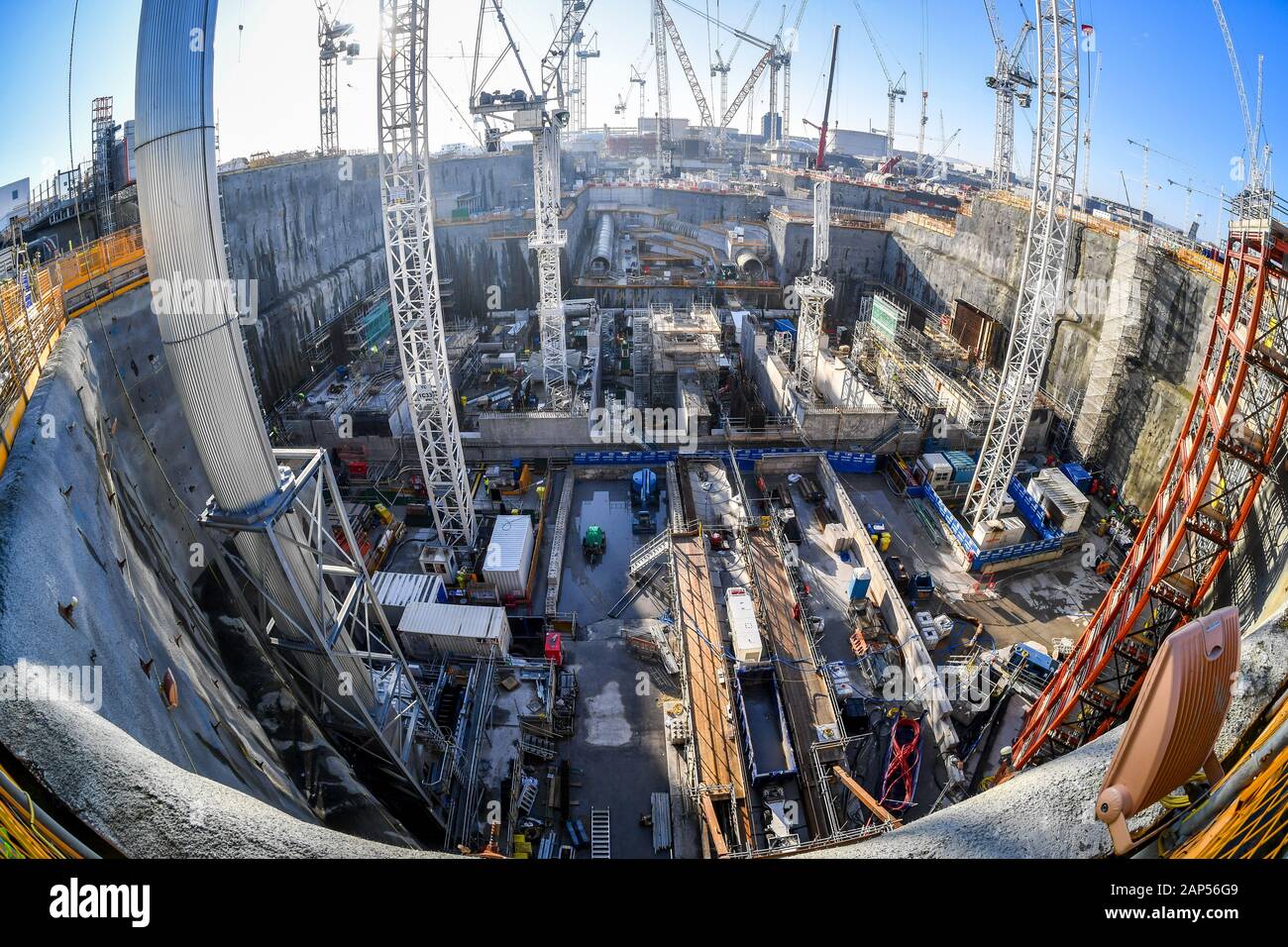 Huge cranes rise up from a deep-dig sectionthat forms part of the cooling network during construction work at Hinkley Point C nuclear power station near Bridgwater, Somerset, where 4,700 workers continue on Europe's largest building site. Stock Photo