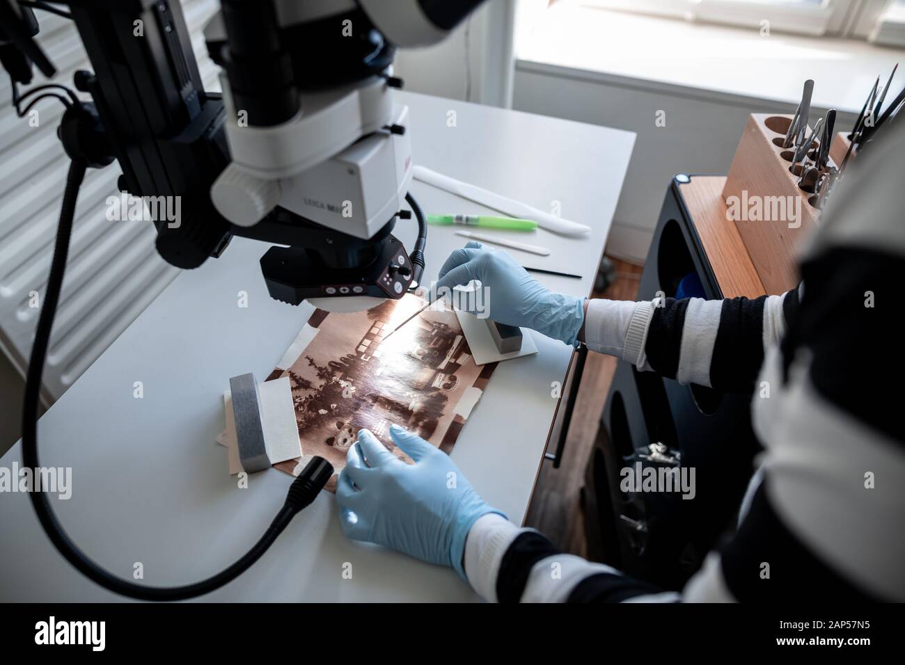 Duesseldorf, Germany. 21st Jan, 2020. The conservator for photography Jessica Morhard examines a rubber print with a microscope. The Düsseldorf City Restoration Centre works on behalf of museums, archives and exhibition houses and was founded in 1976 as a municipal cultural institute. Credit: Fabian Strauch/dpa/Alamy Live News Stock Photo