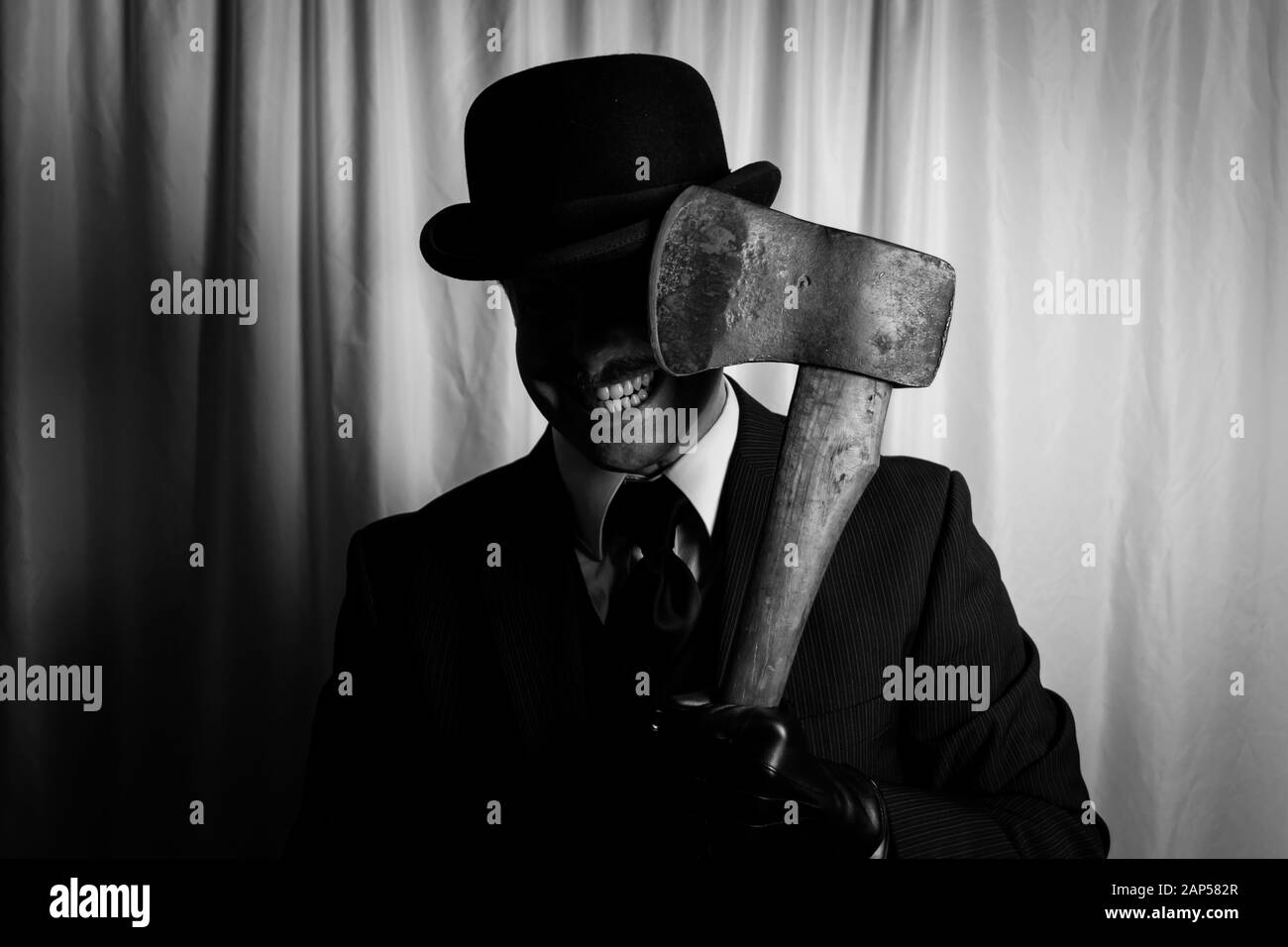 Man With Evil Grin Holding Axe. Concept of Horror Movie Murderer. Stock Photo