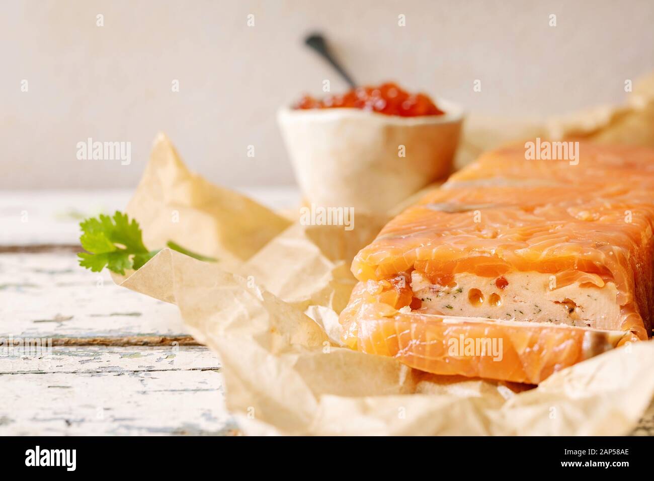 Red salmon caviar in ceramic bowl and homemade salmon terrine served