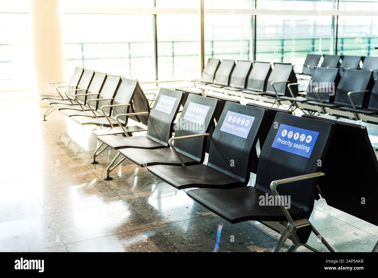 Empty priority seating at an airport in the waiting area before