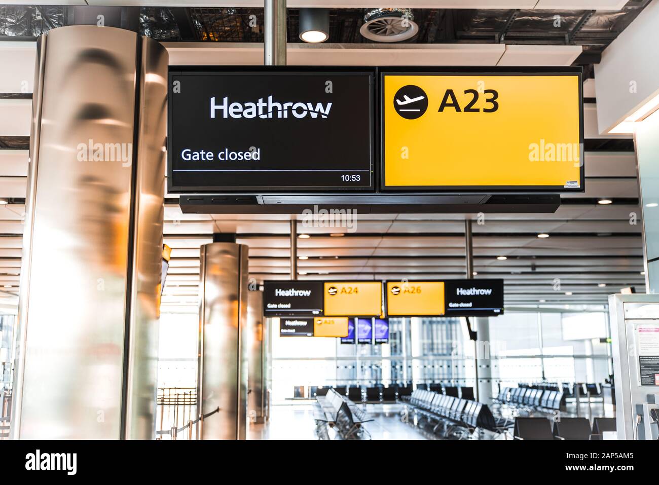 Yellow illuminated signs at airport with gate number. Gate closed Stock Photo