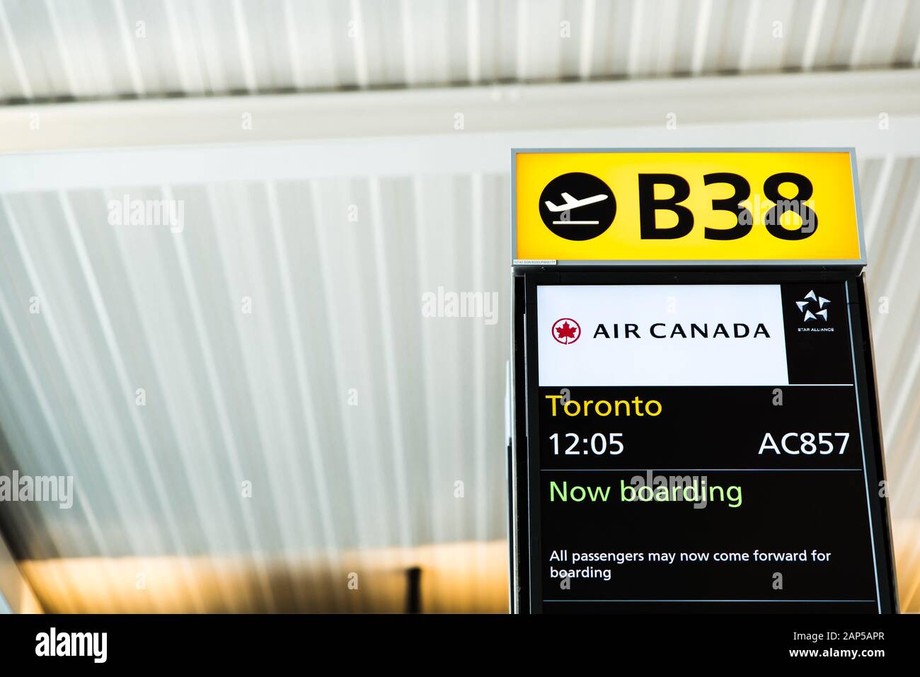 London, Heathrow Airport, Aug 2019: Gate B38 open for boarding. Flight announcement displayed on screen. Flying to Toronto with Air Canada Stock Photo