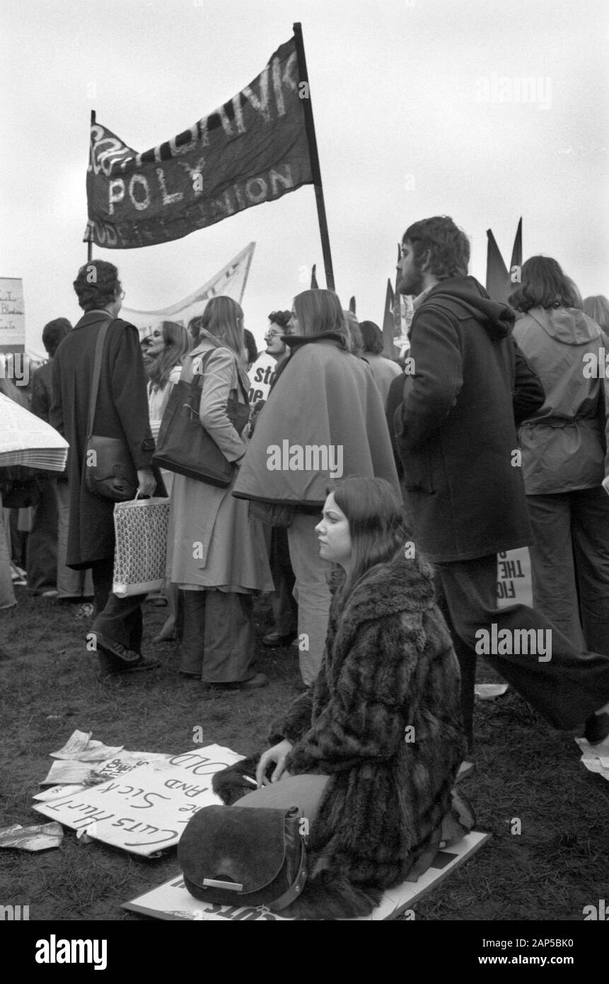 Woman demonstrator smoking and looking depressed sitting down at a Stop the Cuts, Fight for the Right to Work, Defend the NHS Fight for Every Job, rally and march London 1976 Hyde Park London 1970s UK HOMER SYKES Stock Photo