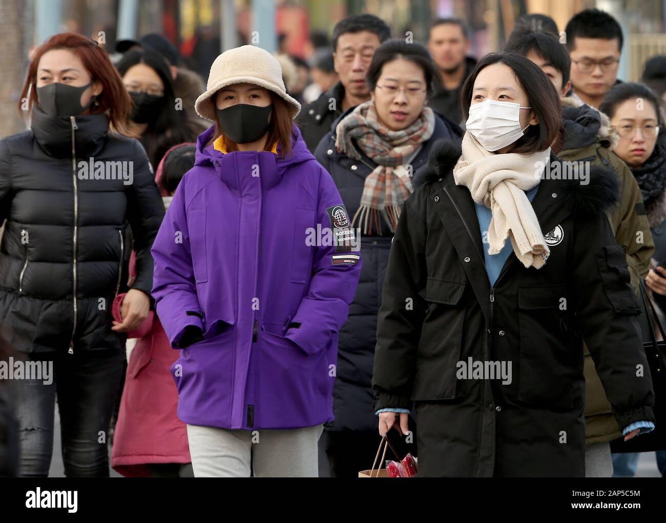 Beijing, China. 21st Jan, 2020. Chinese wear protective respiratory masks in downtown Beijing on Tuesday, January 21, 2020. Health authorities in China reported the country's fourth death from a new type of coronavirus, as the country braces for the Lunar New Year travel boom amid concerns over a possible outbreak similar to that of the SARS virus in the early 2000s. Photo by Stephen Shaver/UPI Credit: UPI/Alamy Live News Stock Photo
