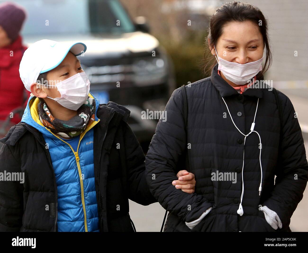 Beijing, China. 21st Jan, 2020. Chinese wear protective respiratory masks in downtown Beijing on Tuesday, January 21, 2020. Health authorities in China reported the country's fourth death from a new type of coronavirus, as the country braces for the Lunar New Year travel boom amid concerns over a possible outbreak similar to that of the SARS virus in the early 2000s. Photo by Stephen Shaver/UPI Credit: UPI/Alamy Live News Stock Photo