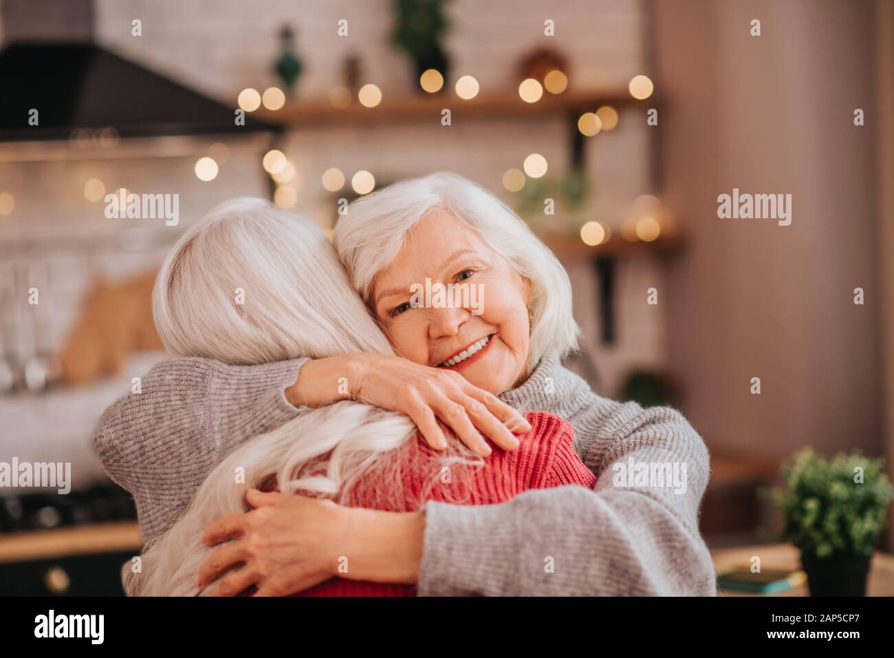 Two mature grey-haired positive ladies feeling happy Stock Photo