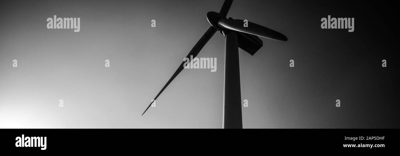 Black and white single wind turbine tower, hub and blades with clear sky Stock Photo Alamy