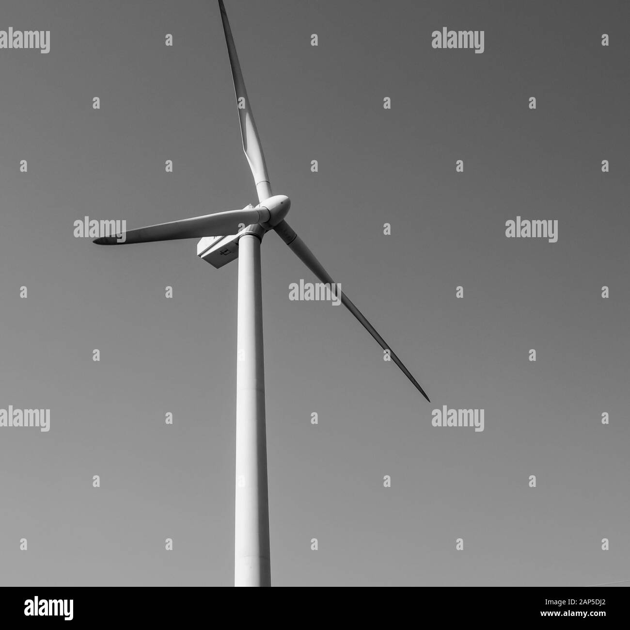Black and white single wind turbine tower, hub and blades with clear sky Stock Photo Alamy