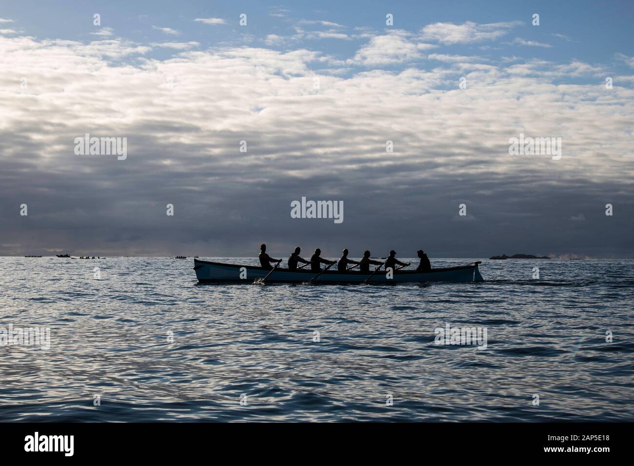 A group of rowers in a pilot gig on the Atlantic Ocean Stock Photo