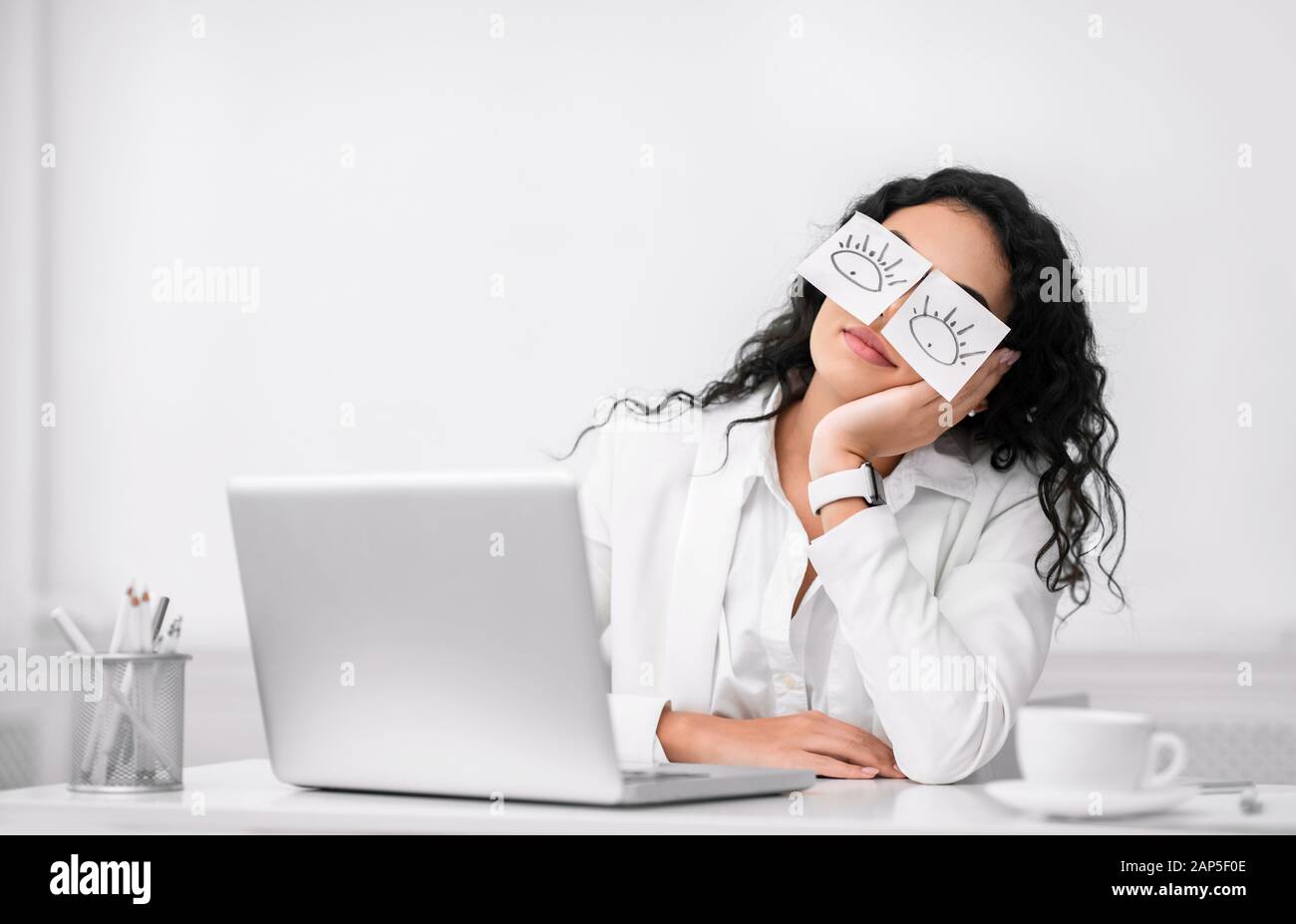 Mexican woman wearing fake eyes painted on paper stickers Stock Photo