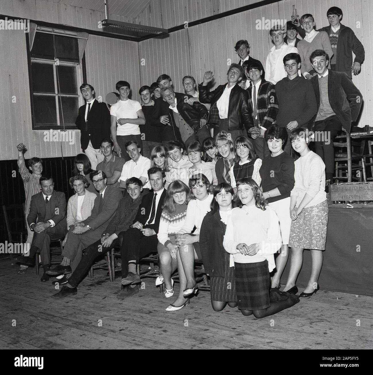 1965, historical, in a village hall, adults and teenage children ...