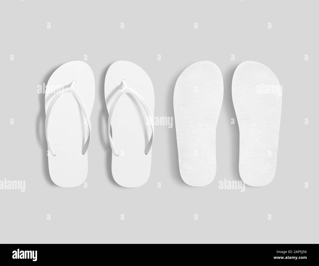 Pair of blank white beach slippers mockup, top sole view Stock Photo