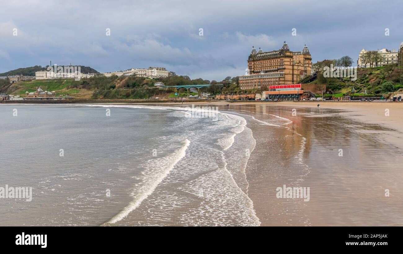South Beach at Scarborough in winter.  Buildings of the town line the waterfront and hotels are on the skyline. Stock Photo