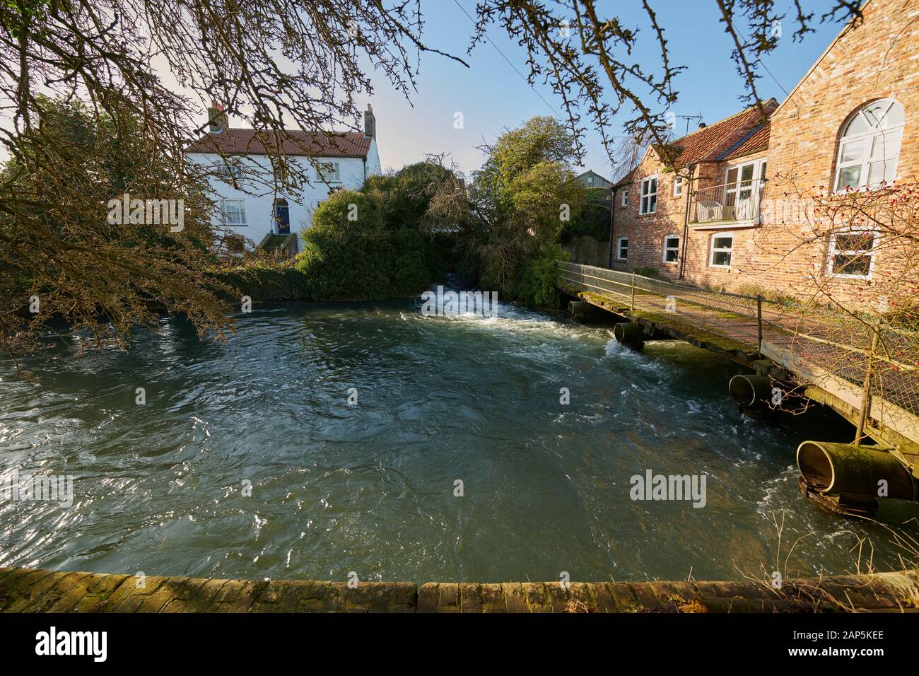 The Old Mill and mill race at Foston on the Wolds, East Riding of Yorkshire, England, UK, GB. Stock Photo