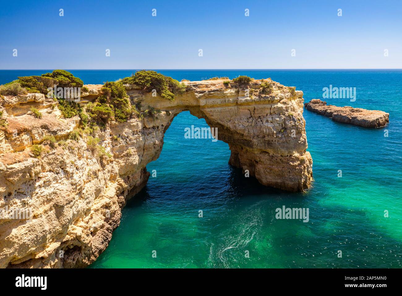 Natural arch above ocean, Arco de Albandeira, Algarve, Portugal. Stone