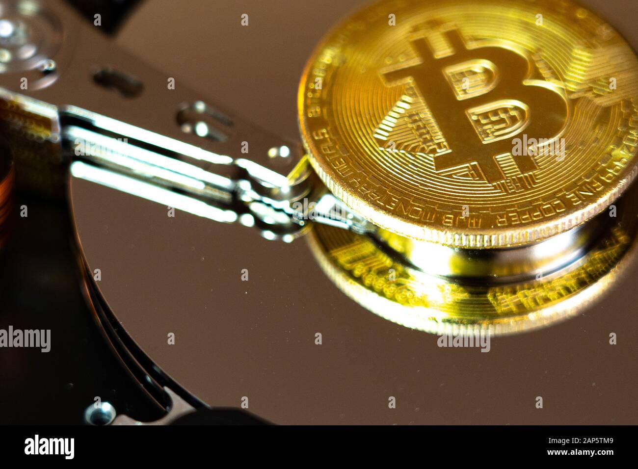 Bitcoin on hdd or harddrive, macro. Cyber security concept, data privacy. Stock Photo