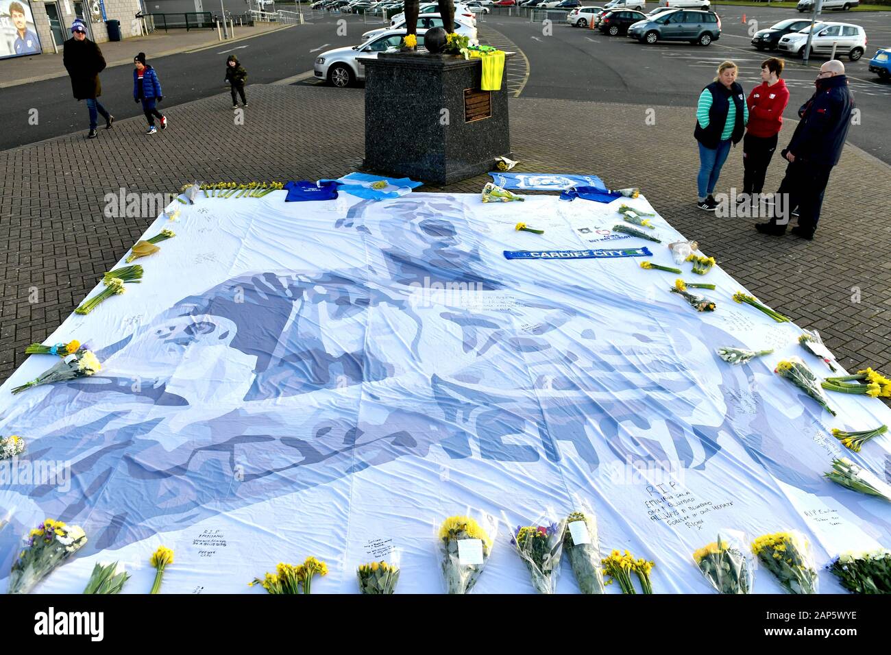 Fans stand near tributes to Emiliano Sala at the Cardiff City Stadium, Cardiff. Stock Photo