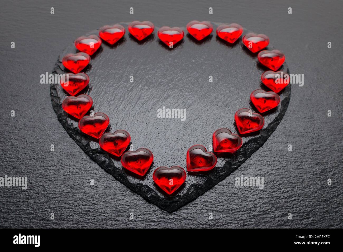 valentines day background with red hearts on black Stock Photo - Alamy