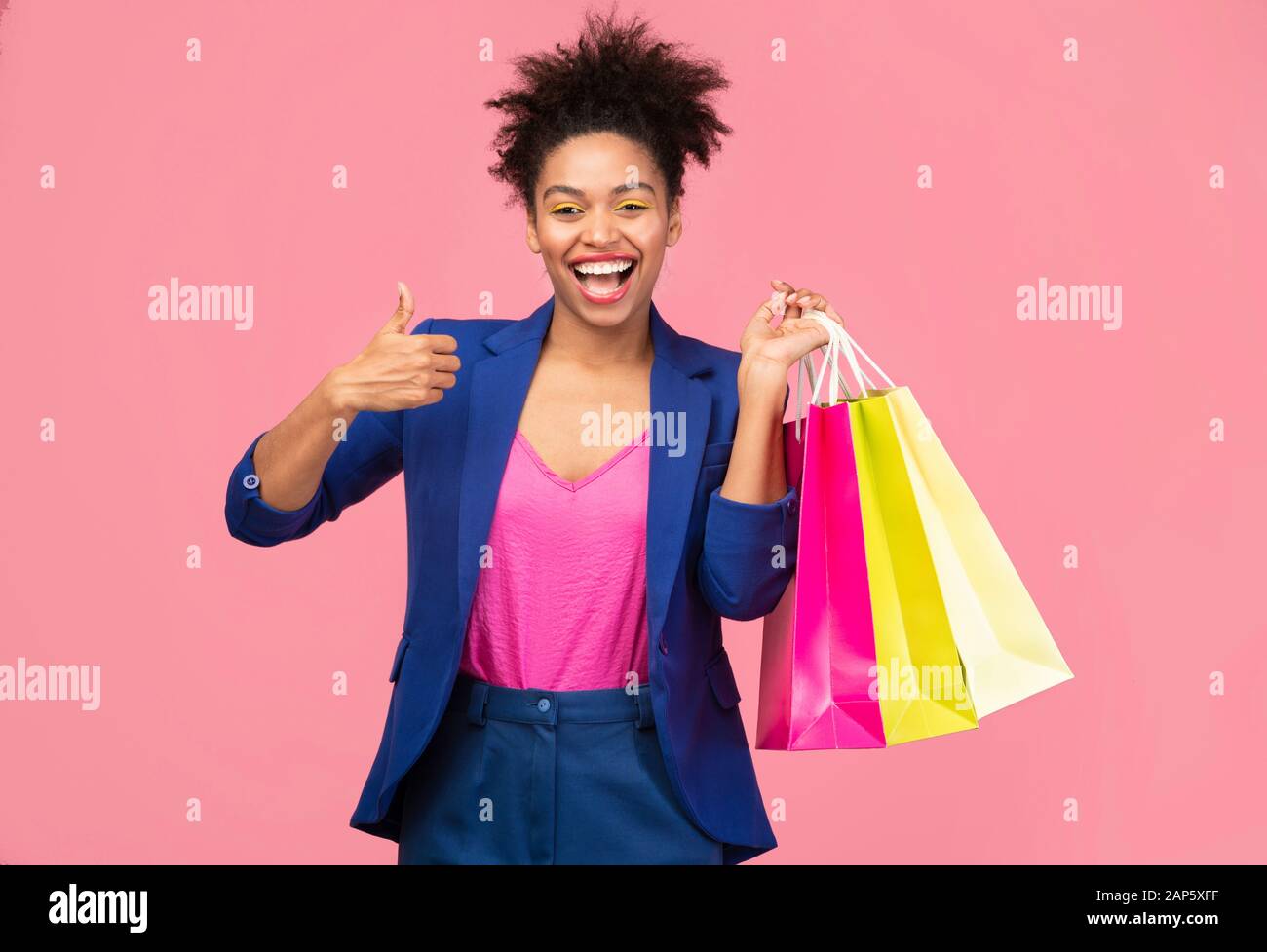 Portrait of cheerful black woman holding shopping bags Stock Photo - Alamy