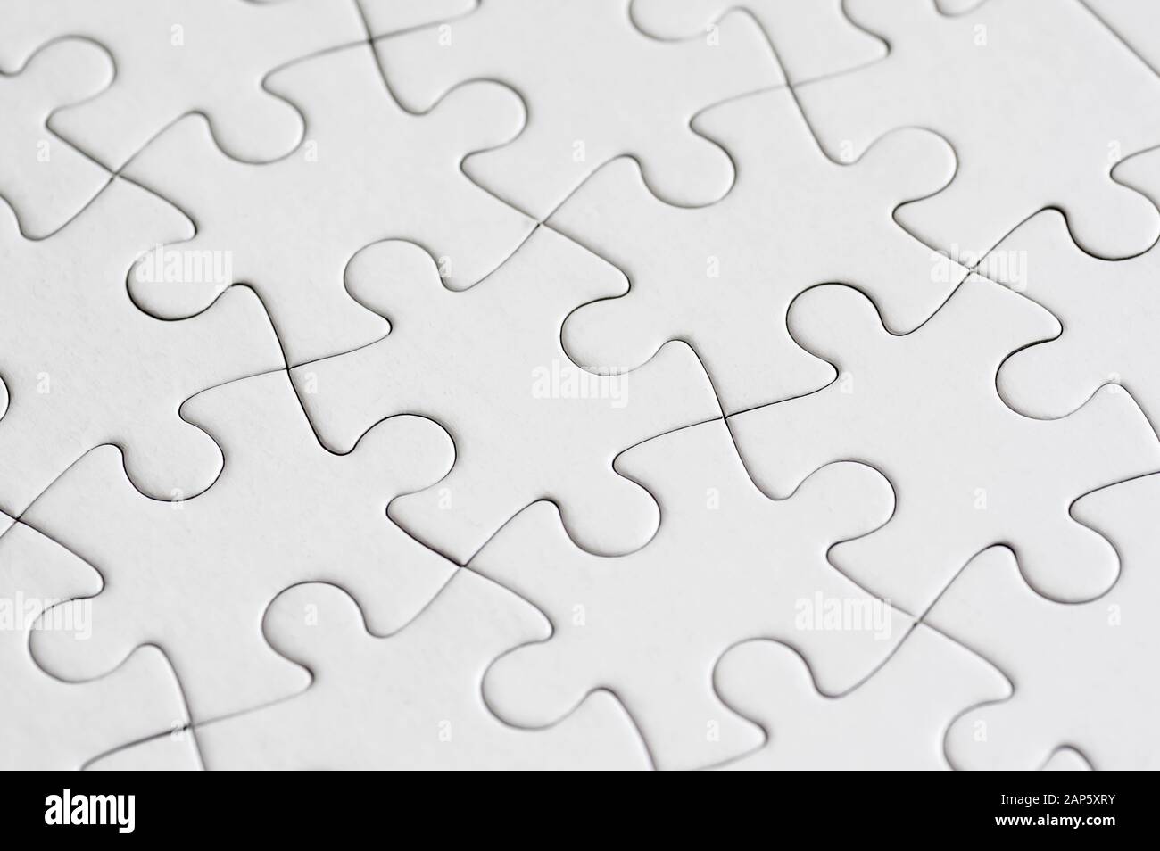 Blank white jigsaw puzzle close up Stock Photo